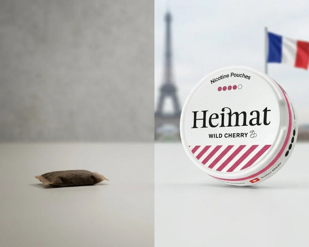 O porție de snus tradițional maro lângă o cutie de pungă de nicotină Heimat Wild Cherry, cu Turnul Eiffel și un steag francez în spate